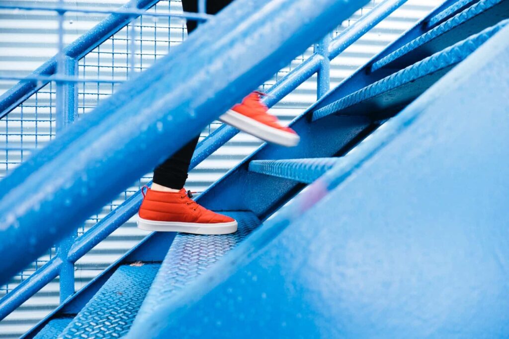 Person stepping over a drawn triangle—symbolising choice to exit the pattern