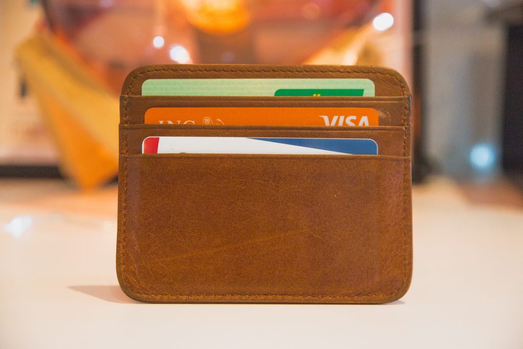 Brown leather card holder containing three bank cards