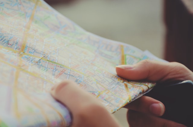 close up of hands holding a street map