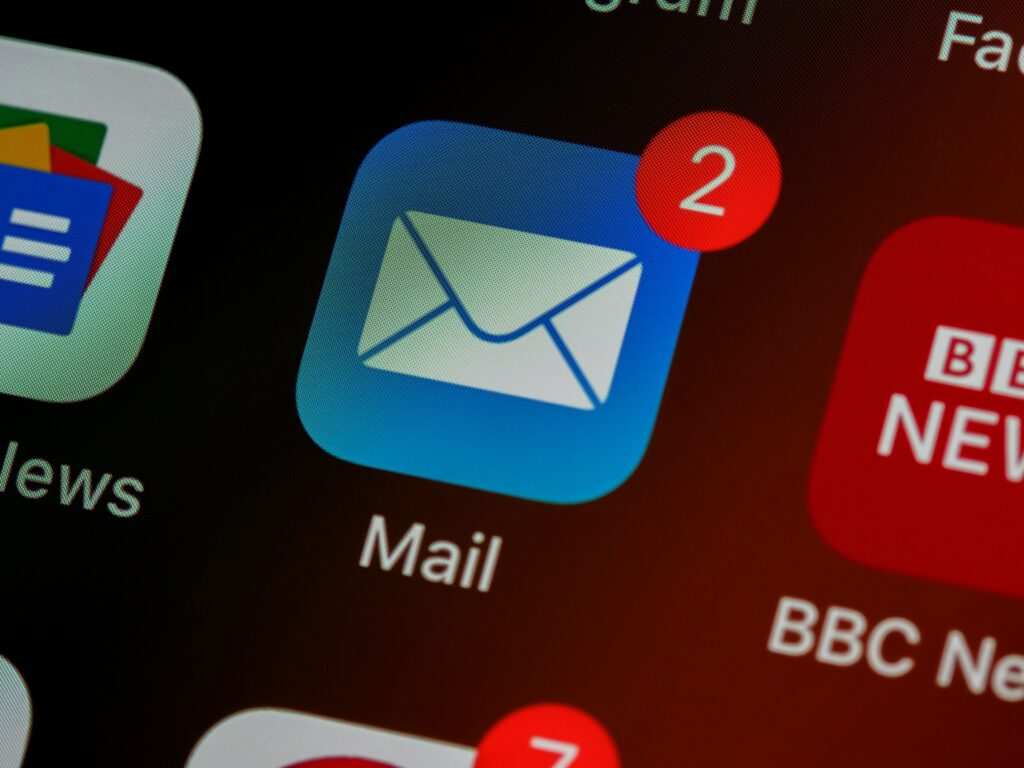 Close up of the mail icon on an iphone with the number 2 in a notification bubble 