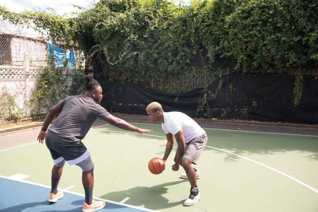 Two men are playing basketball